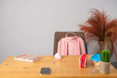 Background banner with a primary school student desk. Pink backpack on the .. Stock Photos