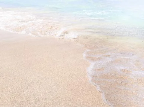 Background beach with sea wave. Texture sand. Gentle pastel colors. Vintage f Stock Photos