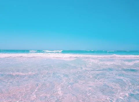 Background beach with sea wave. Texture sand. Gentle pastel colors. Vintage f Stock Photos