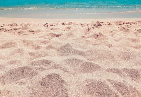Background beach with sea wave. Texture sand. Gentle pastel colors. Vintage f Stock Photos