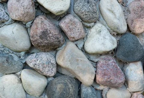 A background of beautiful multi-colored textured stones of different shapes a 写真素材