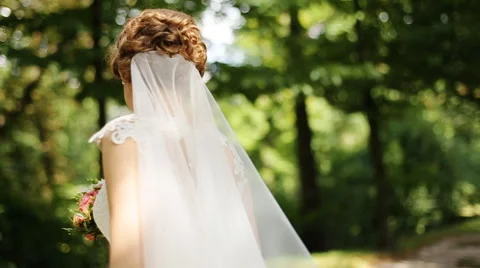 Background behind the back of happy smiling blonde bride with bouquet in the Stock Footage 66004288