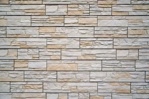 Background of beige bricks. Wall of beige bricks. The texture of the wall Stock Photos
