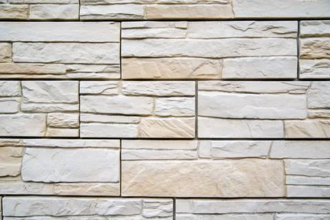 Background of beige bricks. Wall of beige bricks. The texture of the wall. Te Stock Photos