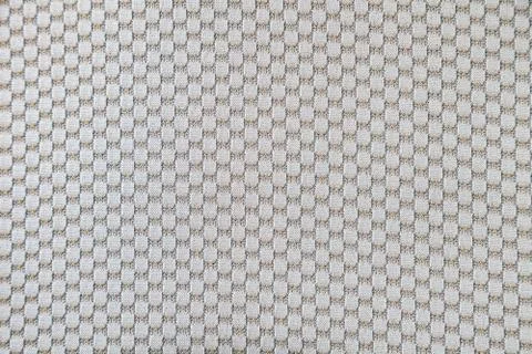 Background from beige textile material with a pattern and threads for clothes Foto stock