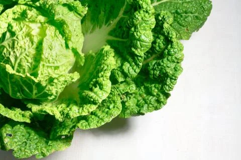 Background with a big fresh cabbage on white wooden background closeup. Stock Photos