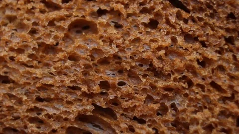 Background of black bread rotating extreme close up, macro shot Stock Footage 83476407