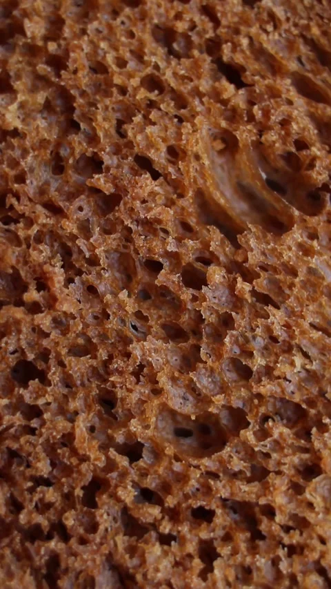 Background of black bread rotating extreme close up, macro shot. Vertical video. Stock Footage 269311204