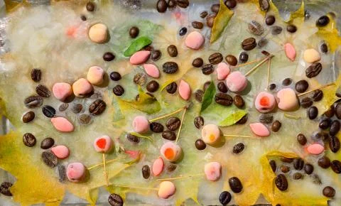 Background of  black coffee beans, red small apple, berry of goji and yellow  Foto stock