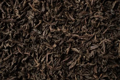 Background of black loose-leaf tea. Close up, top view. Stock Photos