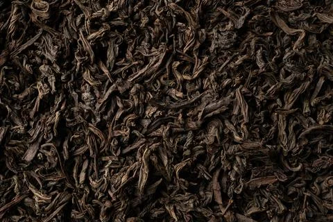 Background of black loose-leaf tea. Close up, top view. Stock Photos
