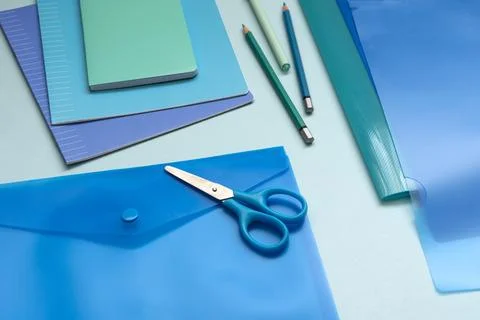 Background with blue office supplies. Folder, notebook, notebook, pencil in.. Stock Photos