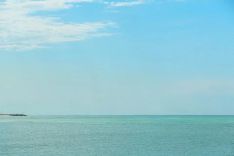 Background of blue sky with beautiful clouds and a small part of the azure se Stock Photos