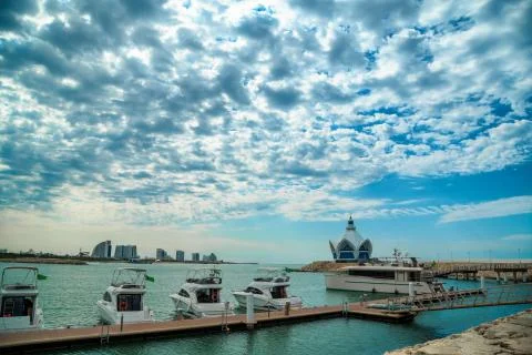 Background of blue sky with beautiful clouds and azure sea with Marina and ya Stock Photos