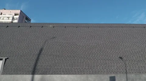 Background in the blue sky bitumen shingles of the round roof of the grey Stock Footage 125815175