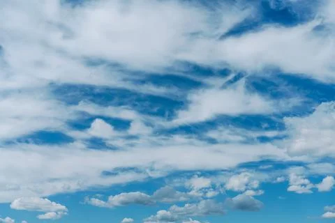 Background of blue sky with fluffy white clouds Stock Photos