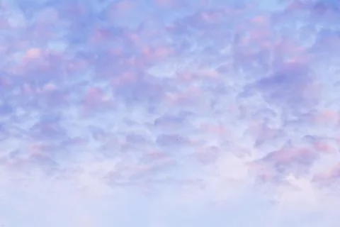 Background of blue sky with pink clouds in sunset Stock Photos
