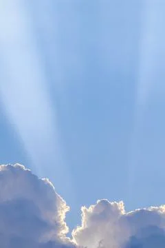 Background from blue sky with sun rays across clouds Stock Photos