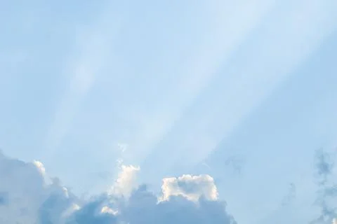 Background from blue sky with sun rays across clouds Foto stock