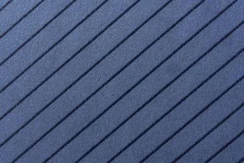 Background of  a blue, textured surface featuring parallel, dark blue diago.. Stock Photos