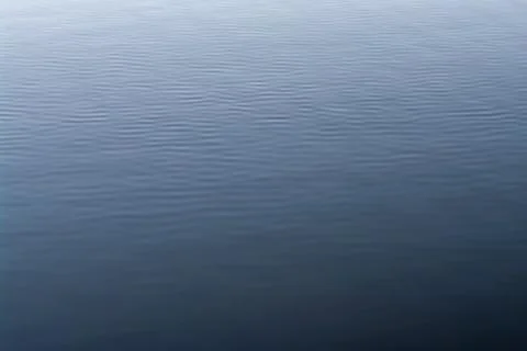 Background of blue water surface with waves Stock Photos