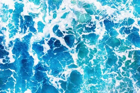 Background blue water texture with wave crest. Concept ocean top view Stock Photos