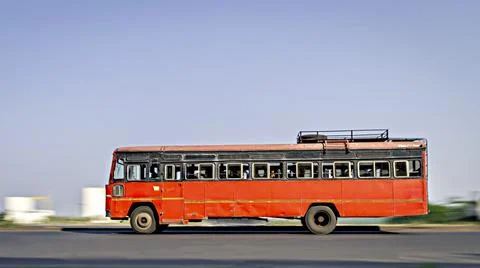 Background blur, pan image of non air-conditioned red intercity bus in Mahara Stock Photos