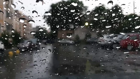Background is blurred. Rain drops on car glass, focus on raindrops. View to the Stock Footage 103551734