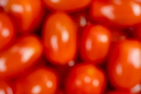 Background of blurred red of cherry tomato. Top view. Blur fresh cherry tomat Stock Photos