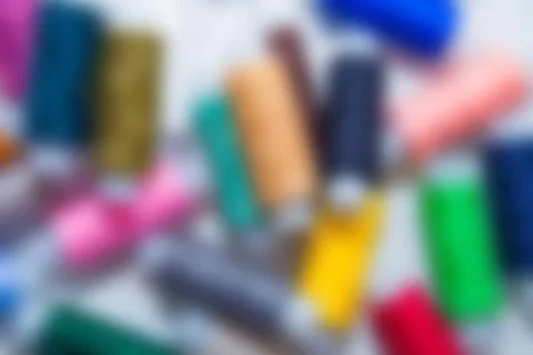 Background blurry image. You can see the outlines of multi-colored threads that Foto stock