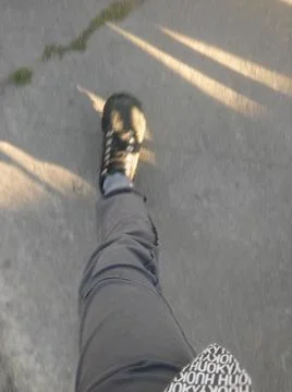 Background with boots in a sidewalk with different elements in daylight Fotos Stock