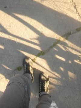 Background with boots in a sidewalk with different elements in daylight Fotos Stock