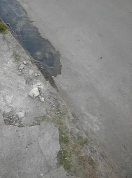 Background with boots in a sidewalk with different elements in daylight 库存照片