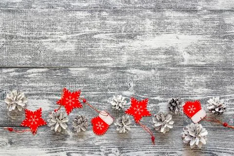 Background with a border of red Christmas decorations and white painted pine Stock Photos