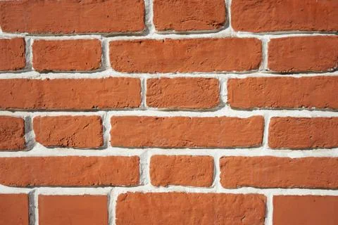 Background brick brown wall with white seams. Stock Photos