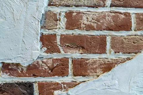 Background of brick stone wall texture with white plaster. Close up image. Stock Photos