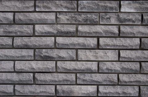 Background from a brick textured gray wall Stock Photos
