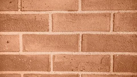 The background of the brick wall. Image toned in Peach Fuzz color of the year Stock Photos