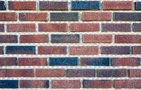 Background of brick wall with multi-colored bricks and transparent grout cement Stock Photos