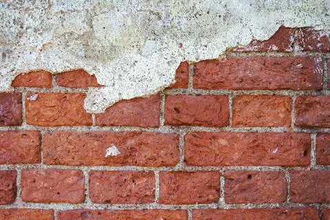 The background of a brick wall with remnants of plaster, the empty texture of Stock Photos