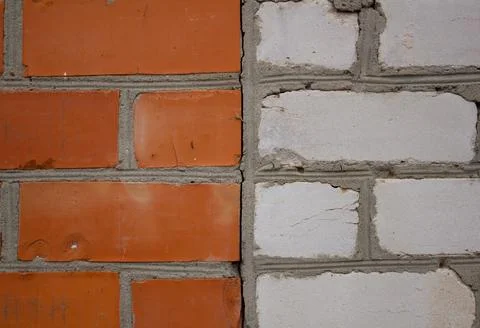 Background of a brick wall where half is lined with red brick and half is white Stock Photos