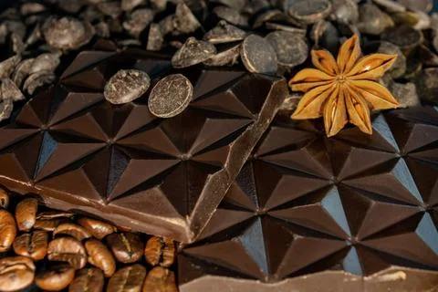 Background of broken chocolate and raw materials, star anise, cocoa, cinnamon Stock Photos