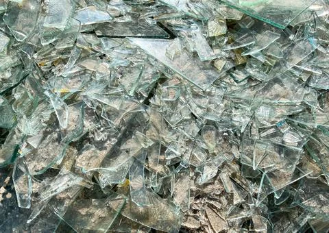 Background of broken glass close-up. The texture of broken glass Stock Photos