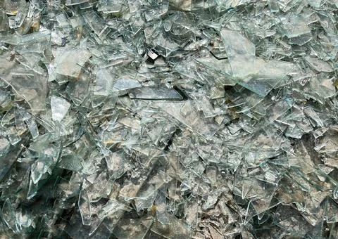 Background of broken glass close-up. The texture of broken glass Stock Photos