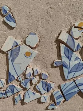 Background of broken traditional ceramic tiles on blue ink mosaic. Stock Photos