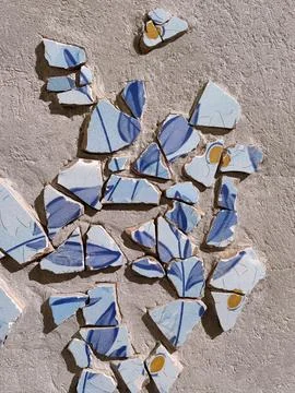 Background of broken traditional ceramic tiles on blue ink mosaic. Stock Photos