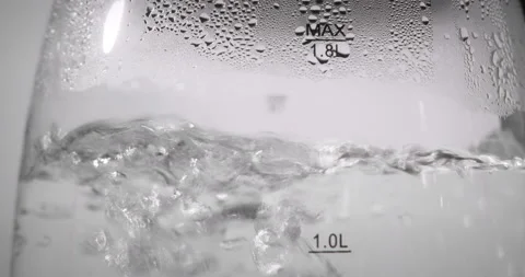 Background, bubbles of hot water in a transparent electric kettle. Close up view Stock Footage 237186280