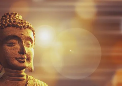 Background with buddha sculpture and rays of light Fotos de archivo