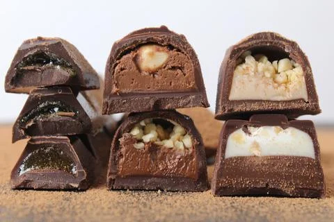 Background of candy candy chocolate. sweets in section with fillings of prali Stock Photos