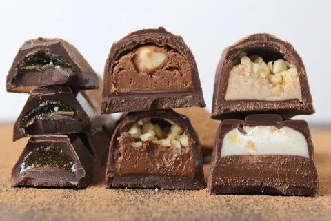 Background of candy candy chocolate. sweets in section with fillings of prali Stock Photos